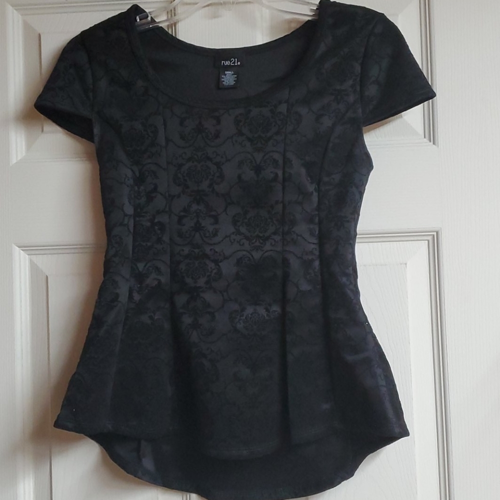 Black peplum top with velvet detail.